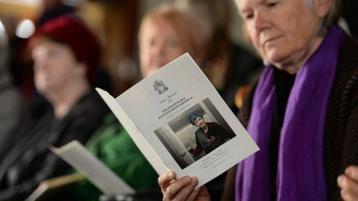 Mourners read from the order of service at the funeral for Joan Kirner. Photo: Justin McManus