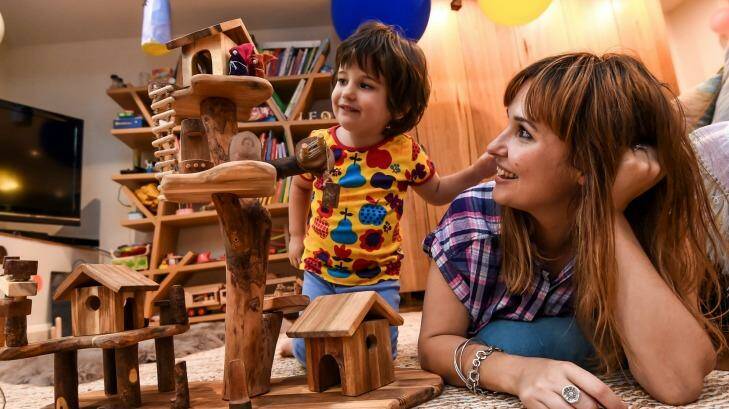 Three-year-old Leo Colosimo having fun with some traditional toys as mum Kristy Biagini looks on. Photo: Justin McManus