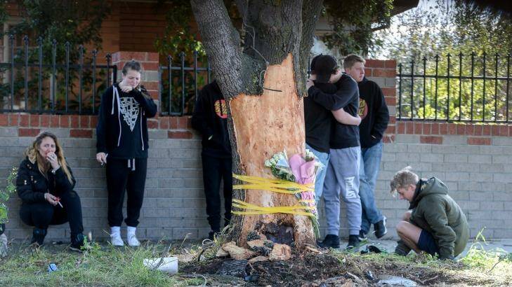 Friends and family lay floral tributes at the scene. Photo: Justin McManus