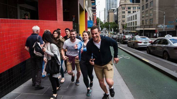 Dave Eastham and his team take off for their Amazing Race-style Urban Quest competition on La Trobe Street. Photo: Josh Robenstone