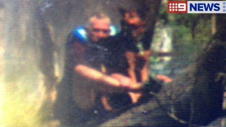 Emergency crews have been called to rescue the  stranded man and his dog. Photo: Courtesy of Nine News