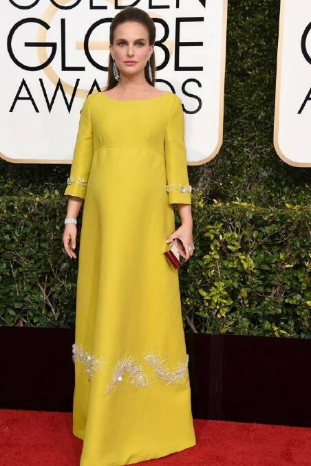 Natalie Portman channels Jackie on the red carpet with a mustard Prada gown and jewels from 1910. Photo: Jordan Strauss