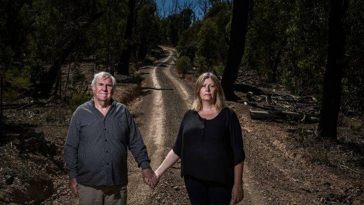 Suzi Kerr and Denis Spooner on the track that Denis used to escape the fire that claimed the life of his wife and son. Photo: Josh Robenstone