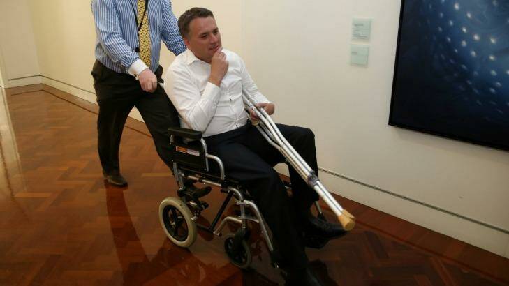 Assistant Infrastructure Minister Jamie Briggs emerged in a wheelchair after a wild party in the Prime Minister's suite.  Photo: Alex Ellinghausen