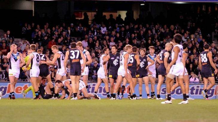 Carlton and Port Adelaide players congregate around the ball during a game in season 2013. Photo: Sebastian Costanzo