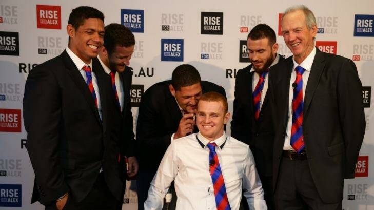 Knights player Alex McKinnon addresses the media for the first time since his accident. Alex is surrounded by teammates, from left, Dane Gagai, Korbin Sims, Willie Mason, Darius Boyd, and coach Wayne Bennett. Photo: Jonathan Carroll