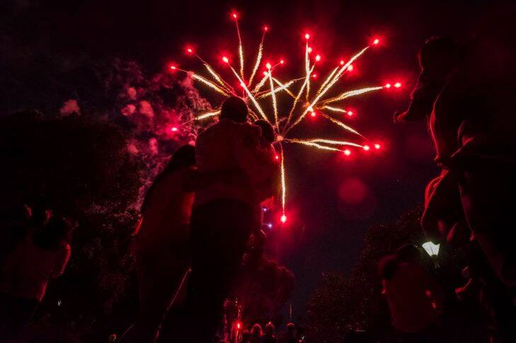 31/12/17 Families enjoy the fireworks on New Years Eve at Yarra Park, Melbourne. Photograph by Chris Hopkins