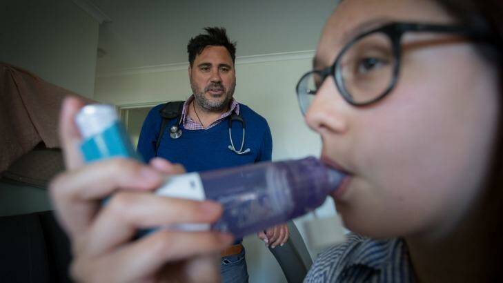 Asthma sufferer Angelique Harkins uses a spacer with her puffer, overseen by Dr Mark Hotu. Photo: Jason South