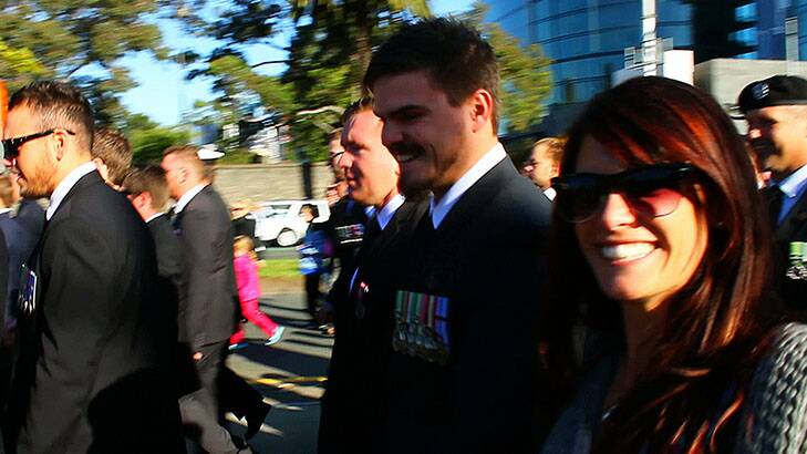 Jessica Wiecek runs alongside her brother Jake, a returned soldier from Afghanistan, at the Anzac Day parade in Melbourne