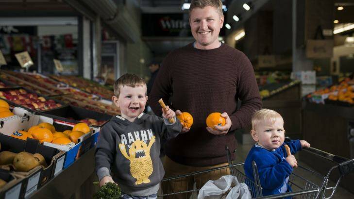 Pete Bromhead, from Jerrabomberra, with his boys Herby, 3, and Oscar, 1, shopping at Fyshwick markets.  Photo: Rohan Thomson