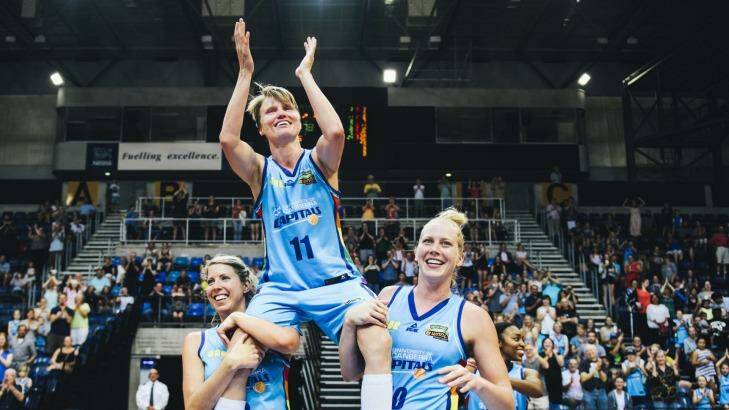 Jess Bibby is carried off by Canberra Capitals teammates Carly Wilson and Abby Bishop after her final WNBL game last season. 
The Canberra Times Photo: Rohan Thomson
