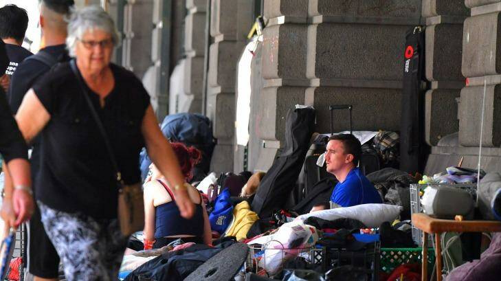 A man sits at the homeless camp outside Flinders Street Station. Photo: Joe Armao