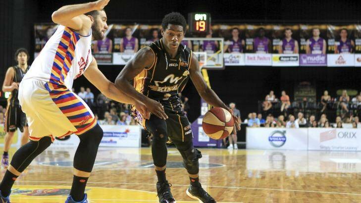 Guarded: Sydney playmaker Kendrick Perry tries to get past Adelaide. Photo: James Alcock