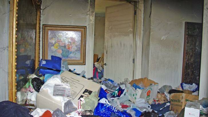 Hoarding in a high-rise unit in Melbourne's south eastern suburbs. The owner was an elderly person who used a mobility aid to climb over a thick layer of rubbish, paper, clothing, boxes and bags. Photo: Metropolitan Fire Brigade