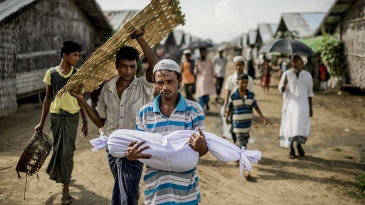 Noor Bashar carries the body of his one-year-old nephew, Mohamad Noor, for burial at a camp for Rohingya in Sittwe, Myanmar, in June 2015.  Photo: New York Times