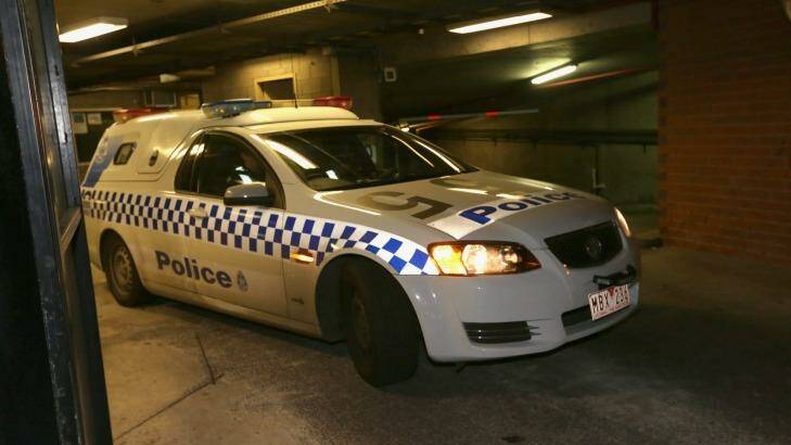 A police car leaves St Kilda Road Police Complex with Hewat on Thursday morning. Photo: Wayne Taylor