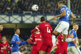 Dominic Calvert-Lewin rises highest to head home Everton's second goal in the derby win v Liverpool. (AP PHOTO)