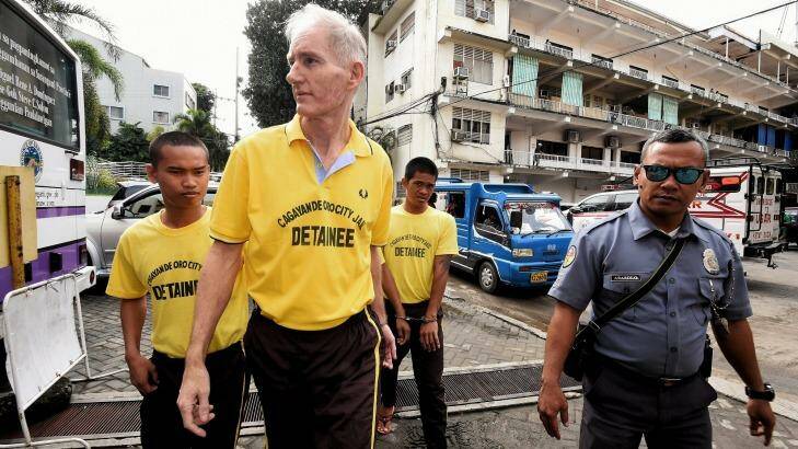 Peter Scully (second from left) arrives at the Cagayan De Oro court handcuffed to another inmate on the first day of his trial in September.  Photo: Kate Geraghty
