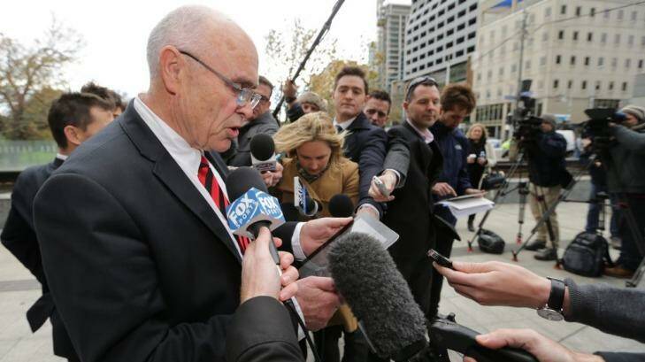 Round one: Essendon chairman Paul Little reads a statement after the Bombers' opening gambit in the Federal Court on Friday.  Photo: Wayne Taylor