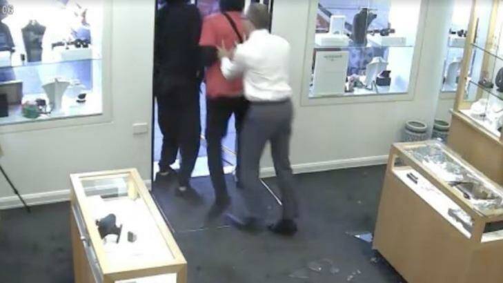The store manager pushes the thieves out the door. Photo: Supplied