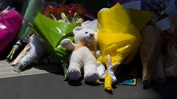 A teddy bear among the flowers on Bourke Street. Photo: Paul Jeffers