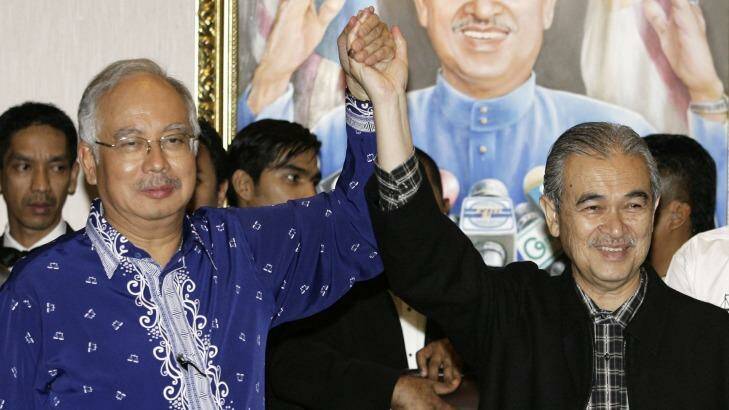 Former Malaysian Prime Minister Abdullah Ahmad Badawi holds hands with his then deputy Najib Razak (left) in 2008. Photo: Tim Chong