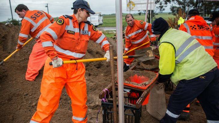 NSW SES crews fill sandbags at SES headquarters in Forbes in preparation for the rain that is expected to fall in the coming days.  Photo: Wolter Peeters