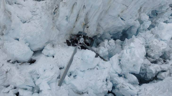 The wreckage of the helicopter, which crashed, killing all seven people on board, is seen in a crevasse on Fox Glacier, New Zealand Photo: NZ Police