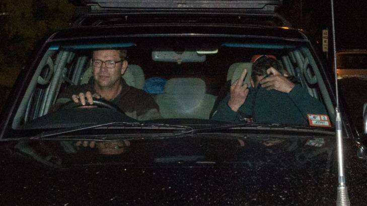 Mark Tromp, pictured right, is driven from the Wangaratta police station on Saturday night. Photo: Mark Jesser
