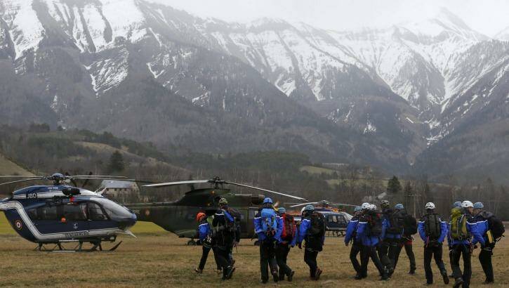 French Police and Gendarmerie Alpine rescue units gather on a field as they prepare to reach the crash site. Photo: REUTERS/Jean-Paul Pelissier
