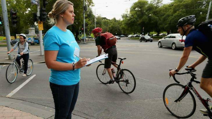 Volunteer Sarah Morrison records cyclists on their way to work on Super Tuesday.  Photo: Wayne Taylor