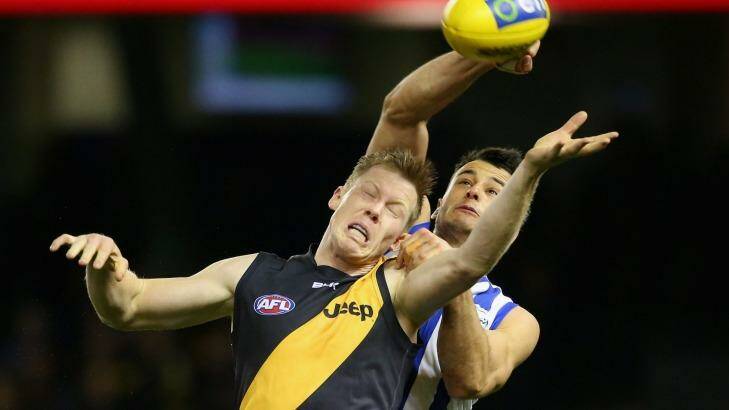 The Tigers' Jack Riewoldt, seen here in a clash with Kangaroos' Robbie Tarrant, was among the players who left SMALF for Precision Sports and Entertainment Group. Photo: Quinn Rooney