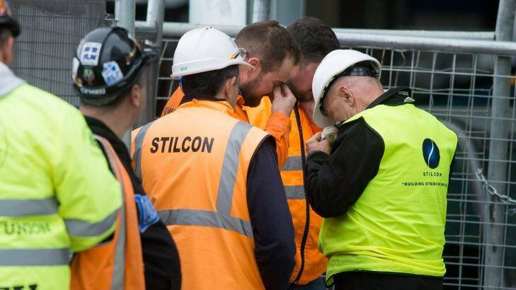 Distressed workers at the scene. Photo: Paul Jeffers