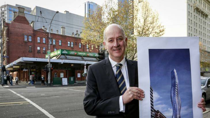 Planning Minister Richard Wynne at the Savoy Tavern site, with a picture of the 68-floor tower.  Photo: Eddie Jim