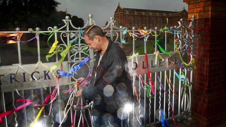 Former St Patrick's College student Peter Blenkiron at St Patrick's College in Ballarat with ribbons which have been attached to the front gate. Photo: Simon O'Dwyer