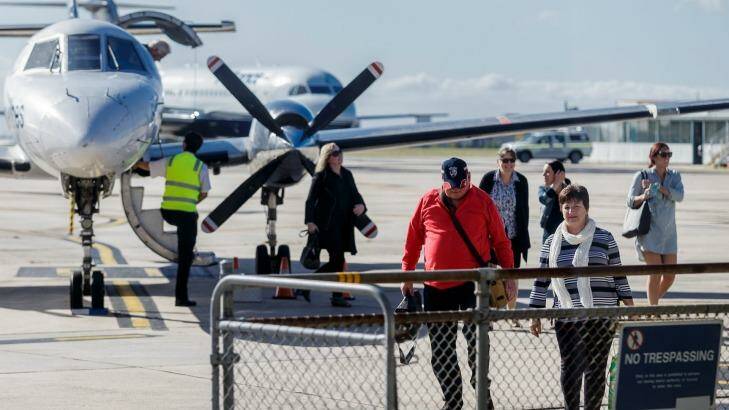 Passengers disembark a chartered flight at Essendon Fields Airport, Melbourne on Thursday. Photo: Daniel Pockett