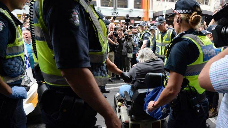 One man in a mobility scooter tried to ram a police car as the homeless were moved on from Flinders Street. Photo: Penny Stephens