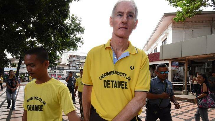 Peter Scully (right) arrives at the Cagayan De Oro court handcuffed to another inmate on his first day of his trial.  Photo: Kate Geraghty