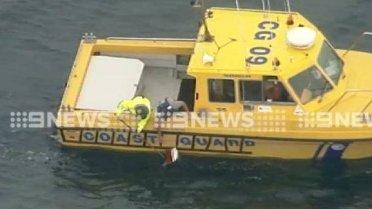 A coast guard boat sifts through wreckage of a plane crash off Barwon Heads. Photo: Channel Nine