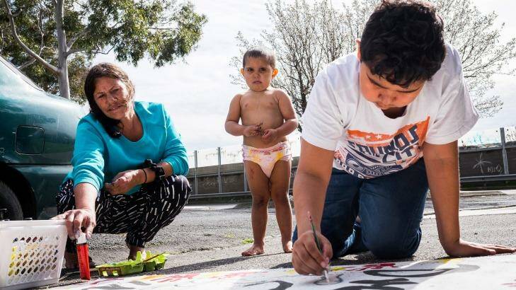 Angela Edwards, pictured with her two grandsons, says after sleeping on the streets for years, squatting in a house in Bendigo Street, Collingwood, provides a secure place for them to visit her.  Photo: Chris Hopkins