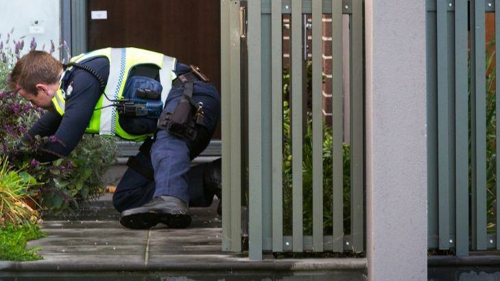 A police officer at the home of Stephen Dank. Photo: Chris Hopkins