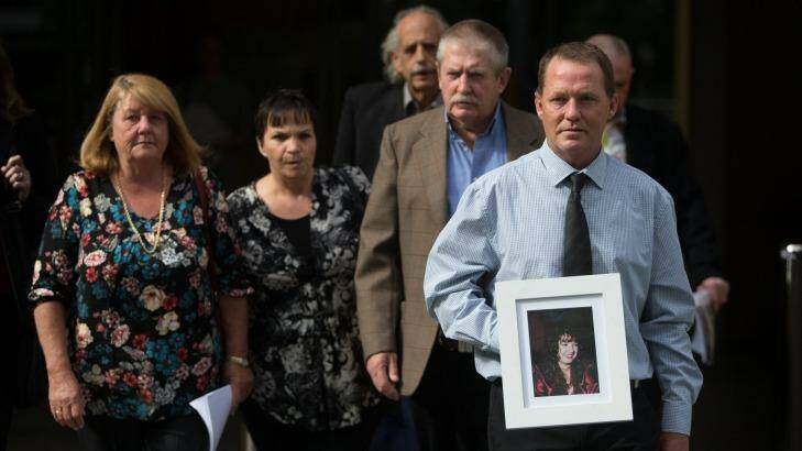 John and Wendy Thompson and family members leave the Coroners Court with a photo of Kelly, who died at the hands of her partner.  Photo: Jason South