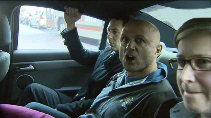 Christopher Binse being taken into custody by police in 2012. Photo: Channel Seven