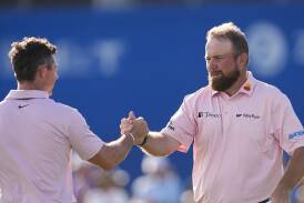 Rory McIlroy (l) and Shane Lowry are joint leaders in the PGA Tour's only teams event. (AP PHOTO)