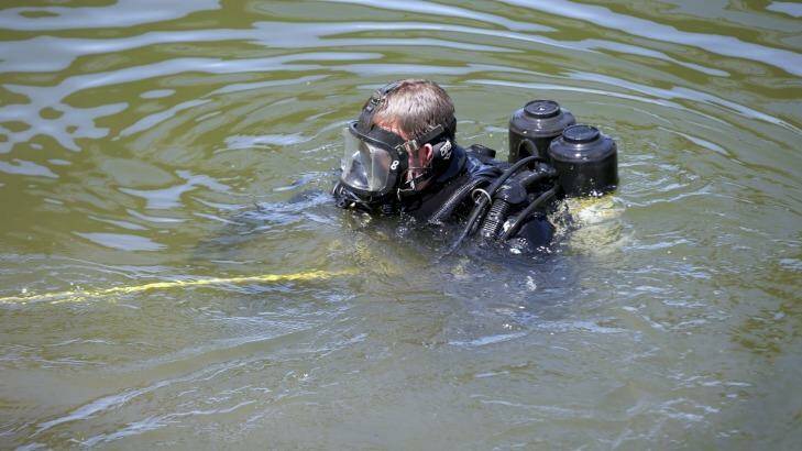 A police diver in the Maribynong River in February. Photo: Simon O'Dwyer