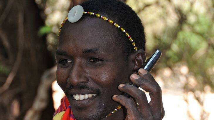 A Samburu warrior in traditional clothes talks on a mobile phone. Photo: Wendy Stone