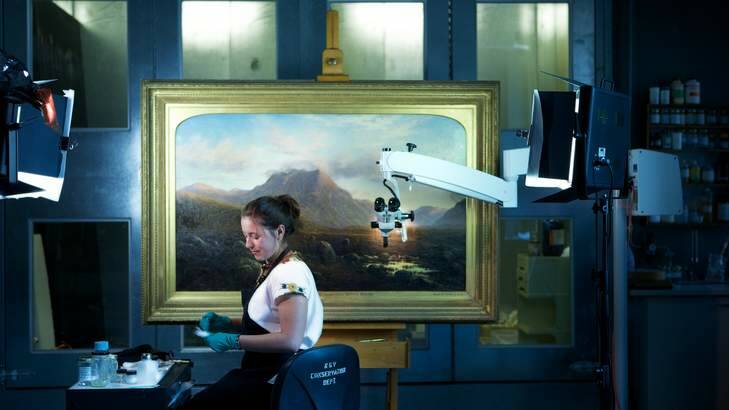 The Age, News. Restoration of a scottish painting at The NGV.restorer Sandi Mtchell with the scottish painting "Entrance to Glen Etive from near Kings house".Pic Simon Schluter  31 March 2014. Photo: Simon Schluter SMS