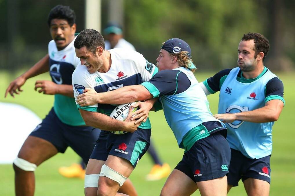 Ready to lift: Dave Dennis runs the ball during a NSW Waratahs training session this week. Photo: Brendon Thorne