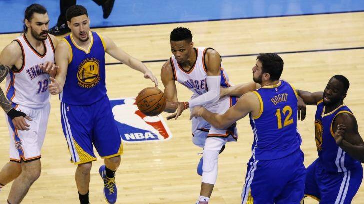 No way through: Oklahoma City Thunder guard Russell Westbrook tries to get past Golden State Warriors defenders Klay Thompson, Andrew Bogut and Draymond Green. Photo: Alonzo Adams