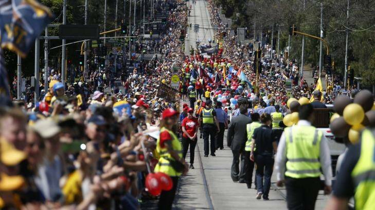 Thousands crammed the grand final parade route, thanks to the public holiday and the good weather. Photo: Eddie Jim